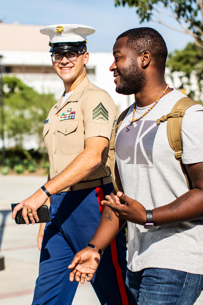Student and Marine Walking on Campus